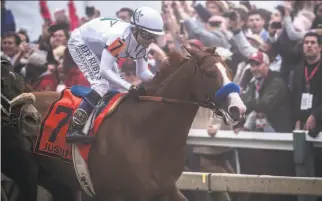  ?? Skip Dickstein / Albany Times Union ?? Justify, with jockey Mike Smith aboard, won the Preakness by less than a length May 19.