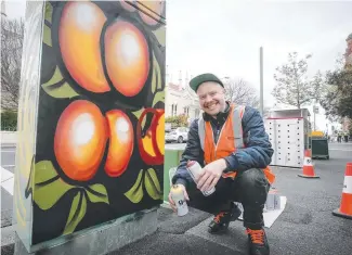  ?? Picture: PATRICK GEE ?? Thomas Chandler’s peaches artwork on a Launceston traffic control box has been inspired by late Australian botanical illustrato­r Margaret Stones.