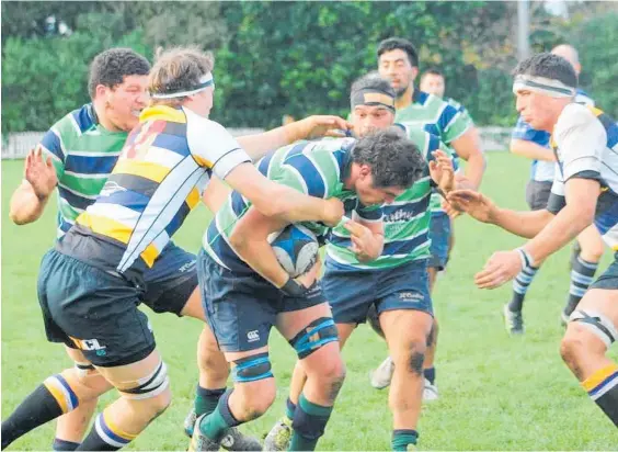  ?? Photo / Merrilyn George ?? Ruapehu’s Campbell Hart hits the ball up against the Border forwards in his team’s upset loss at Dallison Park on Saturday.