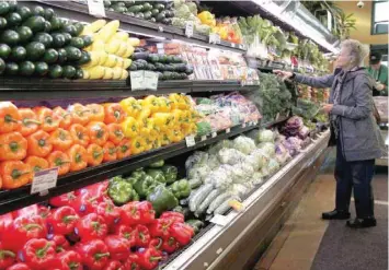  ?? — Reuters ?? A customer shops for fresh produce at the Whole Foods grocery store in Ann Arbor, Michigan, in this file photo.