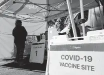  ?? Frederic J. Brown / AFP / Tribune News Service ?? A pop-up clinic offers COVID-19 shots in California. Red and blue states have been hit hard by infections; quit castigatin­g each other, as the virus has had a way of making fools of us all.