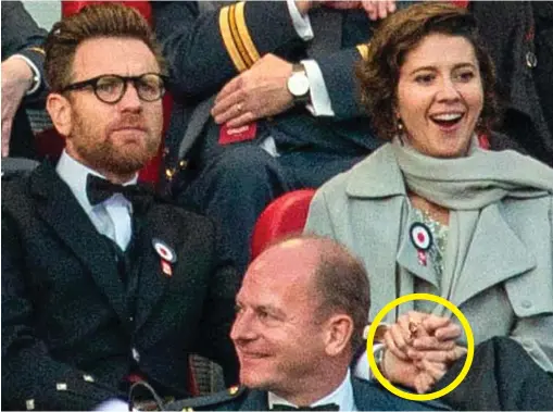  ??  ?? Parading their love: Ewan McGregor and Mary Elizabeth Winstead hold hands, circled, at the Tattoo in Edinburgh