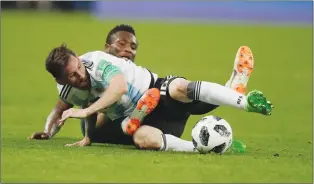  ?? Associated Press photo ?? Argentina’s Lionel Messi, foreground, and Nigeria’s John Obi Mikel compete for the ball during the group D match between Argentina and Nigeria at the 2018 soccer World Cup in the St. Petersburg Stadium in St. Petersburg, Russia, Tuesday.