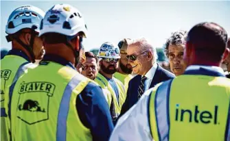  ?? Pete Marovich/New York Times 2022 ?? President Biden meets workers in September at the site of an Intel semiconduc­tor plant in New Albany, Ohio. In his State of the Union address, Biden pointed to the jobs the plant will produce.