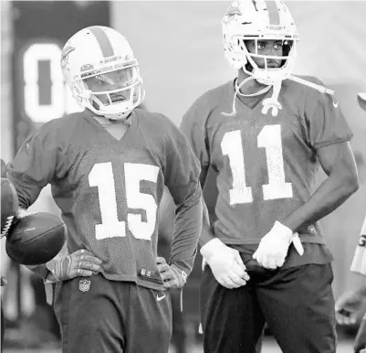  ?? TAIMY ALVAREZ/SUN SENTINEL ?? Albert Wilson, left, and DeVante Parker wear red jerseys while in concussion protocol during practice Thursday in Davie.