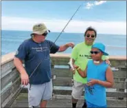  ?? PHOTO COURTESY GREG BORAK — OCEAN CITY FISHING CLUB ?? Bob Dever, an Ocean City Fishing Club member, Tiko Patel, a N.J. WAVE aide, and Messiah, 10, show off their catch at the fishing pier last week.