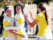  ?? Photo courtesy of JBU Sports Informatio­n ?? John Brown senior Sara Frey, left, is congratula­ted by junior Jastin Redman, middle and sophomore Katherine Haar after Frey scored one of her two goals in a 8-0 win over Southweste­rn Christian (Okla.) on Saturday on Senior Night at Alumni Field.