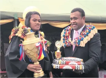  ??  ?? Lami High School Dux Siteri Mami receives her award from Permanent Secretary of the Ministry of iTaukei Affairs Naipote Katonitabu­a at Lami on November 8, 2017. Photo: Losirene Lacanivalu.