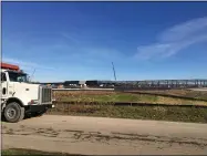  ??  ?? Another dump truck enters the new Carvana auto distributi­on center under constructi­on at 6161 Middle Ridge Road, Elyria Township.