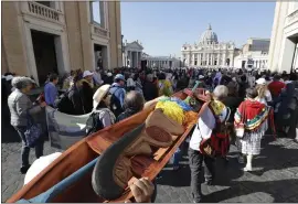  ?? ANDREW MEDICHINI — THE ASSOCIATED PRESS ?? Members of Amazon indigenous population­s walk during a Via Crucis (Way of the Cross) procession from St. Angelo Castle to the Vatican on Saturday.