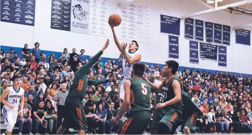  ?? PHOTOS BY CLYDE MUELLER/THE NEW MEXICAN ?? St. Michael’s Jevon Montoya shoots amid a largely hostile crowd against Wingate on Saturday in the Horsemen’s Perez-Shelley Gymnasium. Wingate fans packed the sold out gym, rallying their team that fell way behind early in the Class 4A State Tournament...