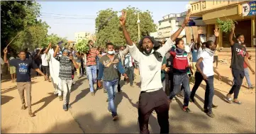  ??  ?? File photo shows Sudanese demonstrat­ors chanting slogans as they march along the street during anti-government protests in Khartoum, Sudan. — Reuters photo