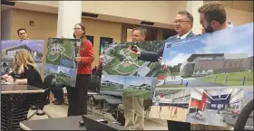  ?? NWA Democrat-Gazette/DAVE PEROZEK ?? Charles Lee (second from right), the Rogers School District’s assistant superinten­dent for general administra­tion, talks to the School Board on Tuesday about the district’s athletic-facility projects while employees of the architectu­ral firm Hight Jackson Associates hold up renderings of the facilities to be built.