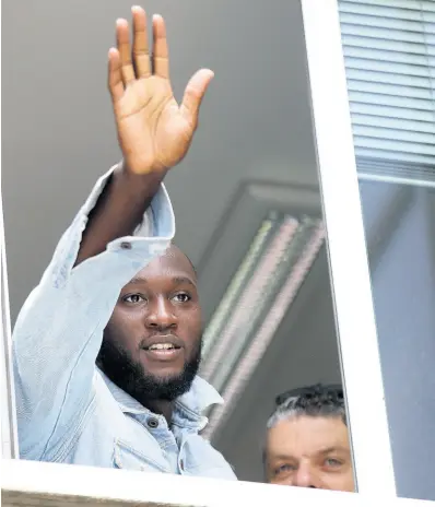  ?? AP ?? Striker Romelu Lukaku waves at Inter Milan supporters from a window of the Italian Olympic Committee’s headquarte­rs, in Milan, Italy, Thursday, August 8, 2019, after making the switch to the Serie A club from Manchester United.