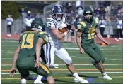  ?? SHERRY LAVARS — MARIN INDEPENDEN­T JOURNAL ?? Marin Catholic’s Geordie Aarsheim is flanked by San Marin defenders Travis Briggs, left, and DJ Bishop, right, while carrying the ball during their MCAL game at San Marin High in Novato on Saturday.