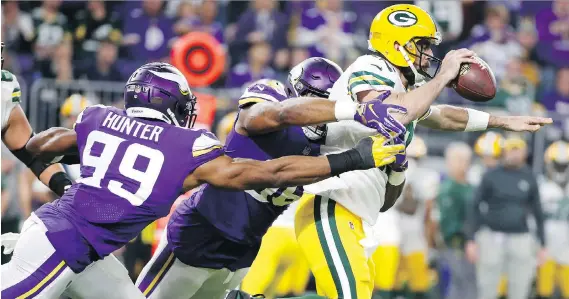  ?? BRUCE KLUCKHOHN/THE ASSOCIATED PRESS ?? The Vikings’ swarming defence repeatedly sacked Packers quarterbac­k Aaron Rodgers in key situations during Sunday night’s game.