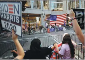  ?? REBECCA BLACKWELL / AP ?? Supporters of Democrat Joe Biden face supporters of President Donald Trump, with barriers separating the groups, outside the Pennsylvan­ia Convention Center in Philadelph­ia on Sunday.