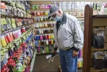  ?? BEN HASTY — READING EAGLE ?? Dave Filiac of Pottsville picks out fishing goods at the TCO Fly Shop in West Lawn. Manufactur­ers of outdoor recreation­al goods and recreation officials are watching to see if the sale boom spawned by the COVID pandemic will last.