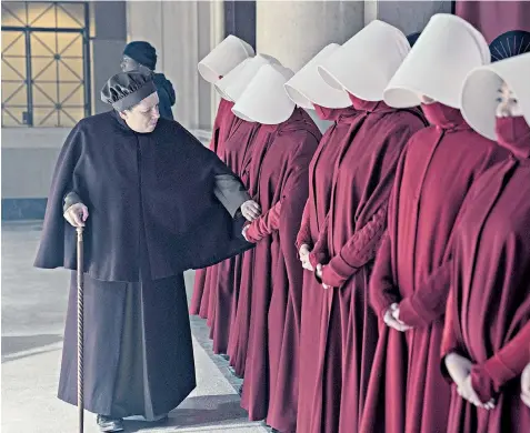  ??  ?? Life in Gilead, as depicted in the television version of The Handmaid’s Tale. Now Margaret Atwood, below, has delivered her eagerly awaited sequel