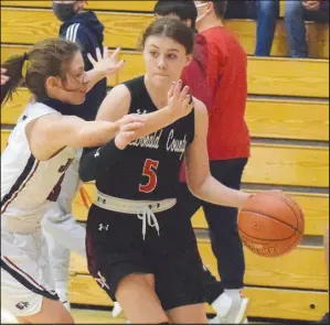  ?? RICK PECK/ SPECIAL TO MCDONALD COUNTY PRESS ?? McDonald County’s Sydney Killion drives past Joplin’s Isabella Yust during the Lady Eagles’ 34-25 win on Nov. 30 in the Freeman Sports Medicine CJ Classic at Carl Junction High School.