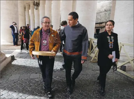  ?? (File Photo/AP/Alessandra Tarantino) ?? Gerald Antoine (from left), First Nations NWT Regional Chief, Natan Obed, President of Inuit Tapiriit Kanatami delegation, and Cassidy Caron, President of the Metis community, walk in St. Peter’s Square, at the Vatican, after their meeting with Pope Francis on April 1. The restitutio­n of Indigenous and colonial-era artifacts, a pressing debate for museums and national collection­s across Europe, is one of the many agenda items awaiting Francis on his trip to Canada, which began Sunday.