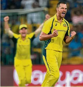  ?? — AFP ?? On a high: Australian bowler Nathan Coulter-Nile celebratin­g the dismissal of India captain and batsman Virat Kohli for 21 runs during the fourth oneday internatio­nal in Bangalore on Thursday.