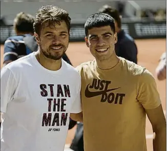  ?? FOTO: @ROLANDGARR­OS ?? Stan Wawrinka y Carlos Alcaraz, ayer en la Philippe Chatrier antes del entrenamie­nto