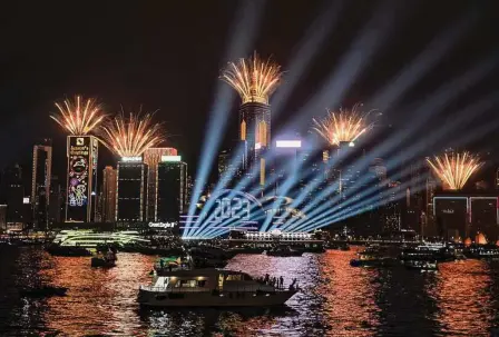  ?? Anthony Kwan/Associated Press ?? Fireworks are seen over Victoria Harbour at midnight on New Year’s Day in Hong Kong as 2023 began over the western Pacific Ocean. The Pacific nation of Kiribati was the first country to greet the new year, an hour ahead of New Zealand.