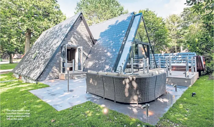  ??  ?? The ultra-modern and luxurious Glass Lodge boasts a secluded hot tub on the patio