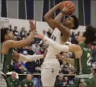  ?? JEN FORBUS — FOR THE MORNING JOURNAL ?? Elyria Catholic’s Jarred Logan (left) and Jack Griffin try to defend a shot from Lorain’s Devon Grant on Feb. 12.