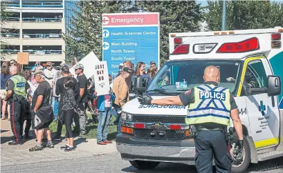  ?? JEFF MCINTOSH THE CANADIAN PRESS ?? Protesters gathered outside the Foothills Hospital in Calgary this week to oppose COVID-19-related public health measures as a fourth wave engulfs the province, putting additional pressure on health-care staff who are dealing with fatigue and burnout.