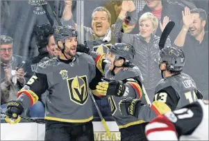  ?? AP PHOTO/JOHN LOCHER ?? Vegas Golden Knights defenceman Deryk Engelland, left, celebrates after scoring against the Arizona Coyotes during the first period of an NHL hockey game in Las Vegas on Tuesday.