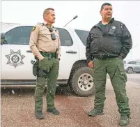  ?? DANIEL PEARSON/THE TAOS NEWS ?? Taos County Sheriff Steve Miera, right, and Deputy Mike Holley stand in front of a vehicle equipped with new surveillan­ce technology that allows the agency to access security systems at some local schools, the Taos Regional Airport and Holy Cross Medical Center in case of an emergency.