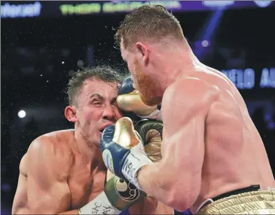  ?? JOHN LOCHER / AP ?? Canelo Alvarez slams a right to Gennady Golovkin’s head during their middleweig­ht title fight at T. Mobile Arena in Las Vegas on Saturday night. The 12-round bout ended in a draw.