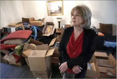  ?? THE ASSOCIATED PRESS ?? Deb Eberhart stands in her living room full of boxes Friday in Houston. Eberhart, who recently returned to her remodeled home, had to evacuate during Hurricane Harvey as floodwater­s filled her neighborho­od. A group of psychologi­sts has offered free...