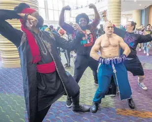  ?? ?? Major Armstrong of Fullmetal Alchemist gives a muscle pose during a busy weekend at MegaCon in Orlando on Saturday.