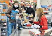  ??  ?? Bare essentials; Angela Buttolph with her latest online shop. Left, queues in Italian supermarke­ts