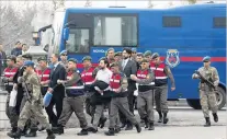  ?? PHOTO: REUTERS ?? Turkish soldiers accused of attempting to assassinat­e President Tayyip Erdogan are escorted to trial in Mugla, Turkey, by gendarmes.