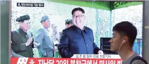  ?? AFP ?? A man passes by a TV news showing a file image of North Korean leader Kim Jong-un, at the Seoul Railway Station in Seoul, South Korea, on Sunday. —