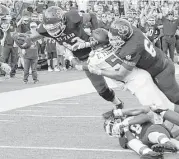  ?? Michael Wyke ?? Cy-Fair’s Trenton Kennedy, left, dives into the end zone for one of his three rushing touchdowns in Saturday’s victory over Langham Creek.