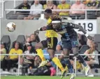  ?? BARBARA J. PERENIC/THE COLUMBUS DISPATCH ?? Crew midfielder Yaw Yeboah battles for a ball with Philadelph­ia defender Olivier Mbaizo on Saturday.