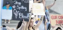  ?? PHOTO: SUN SENTINEL/TNS ?? Action! . . . Protesters hold placards at the Federal Courthouse in Fort Lauderdale , yesterday.