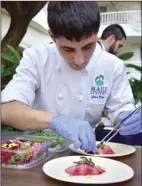  ?? UH-MC photo ?? UH-MC student chef Chris Rego carefully plates an appetizer at last year’s Noble Chef gala.The students will be there in full force this year.