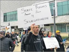  ?? AP PHOTO ?? Graduate student Steven Lynn holds up a sign during a protest against U.S. Attorney General Jeff Sessions, who was speaking to the California Peace Officer Associatio­n meeting in Sacramento, Calif.