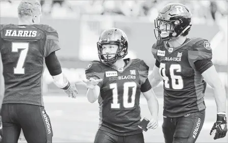  ?? PETER POWER
THE CANADIAN PRESS ?? Ottawa Redblacks kicker Lewis Ward celebrates with quarterbac­k Trevor Harris during second-half Canadian Football League action against the Tiger-Cats at Tim Hortons Field in Hamilton on Saturday. Ward booted seven field goals in the Ottawa victory.