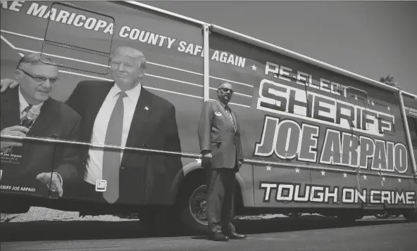  ?? ASSOCIATED PRESS ?? FORMER MARICOPA COUNTY SHERIFF JOE ARPAIO poses for a photograph in front of his campaign vehicle Wednesday in Fountain Hills. Arpaio is trying to win back the sheriff’s post in metro Phoenix that he held for 24 years. He and his former second-in-command, Jerry Sheridan, are engaged in a tight race in the Aug. 4 Republican primary.