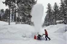  ?? Salgu Wissmath/The Chronicle ?? Joe Roop clears snow with a snowblower in front of his rental property along Larch Avenue on March 1 in South Lake Tahoe.