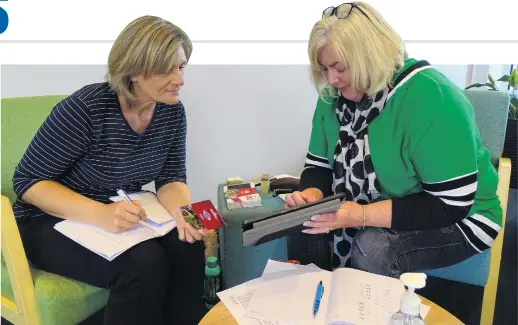  ?? PHOTO: KERRIE WATERWORTH ?? The last step in the process . . . Wanaka volunteers Julia Larkin (left) and Rachelle Blatch at the Wanaka Community Hub distribute supermarke­t vouchers.