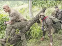  ?? COLUMBIA PICTURES ?? Dwayne (The Rock) Johnson, left, Kevin Hart and Nick Jonas are the key players in Jumanji: Welcome to the Jungle.