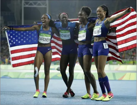  ?? JAE C. HONG — THE ASSOCIATED PRESS ?? The United States’ English Gardner, Tori Bowie, Tianna Bartoletta of Elyria and Allyson Felix, from left, celebrate winning the gold medal in the women’s 4x100 relay at the 2016 Summer Olympics in Rio de Janeiro.